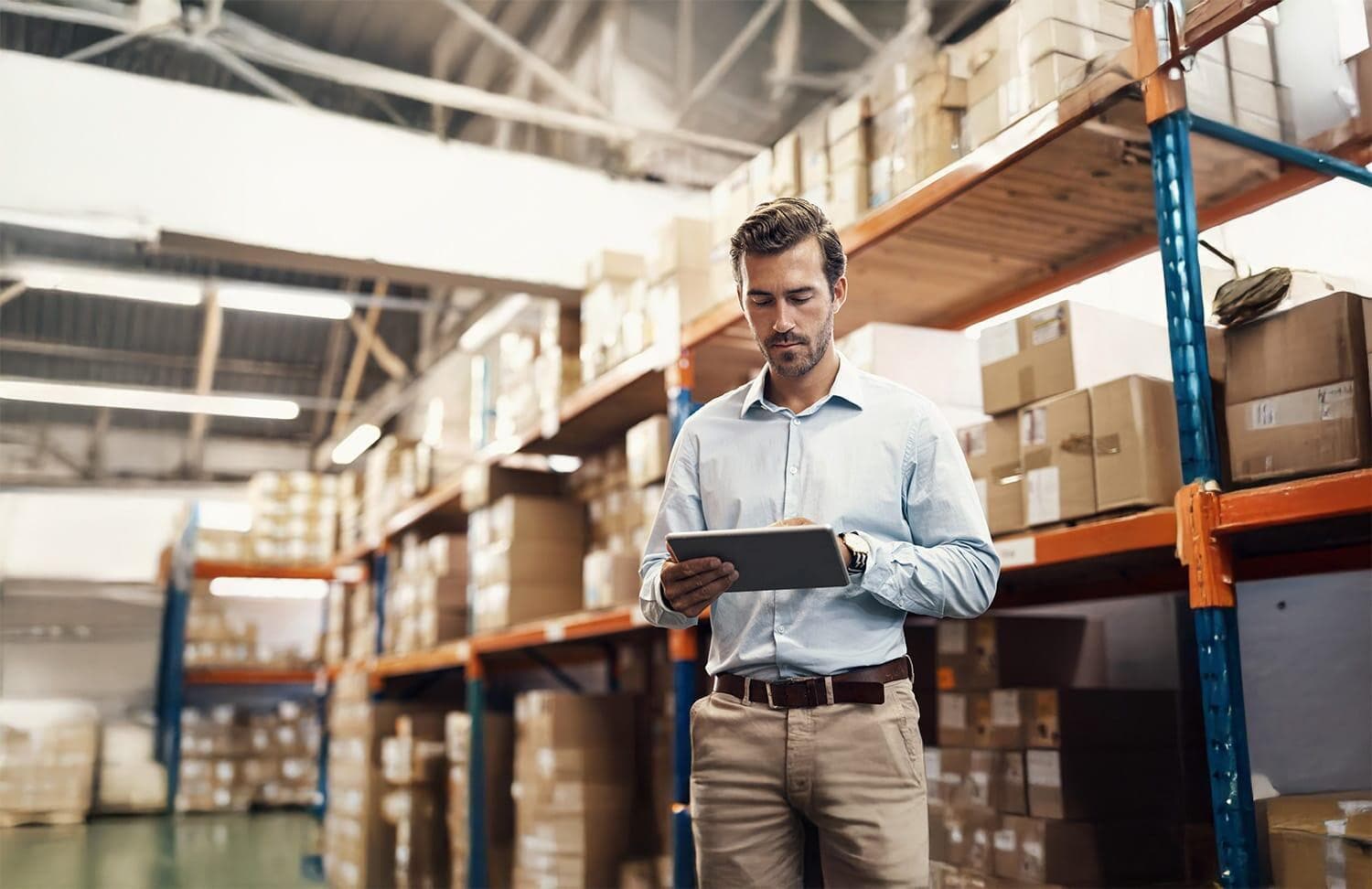 Man working on tablet in warehouse
