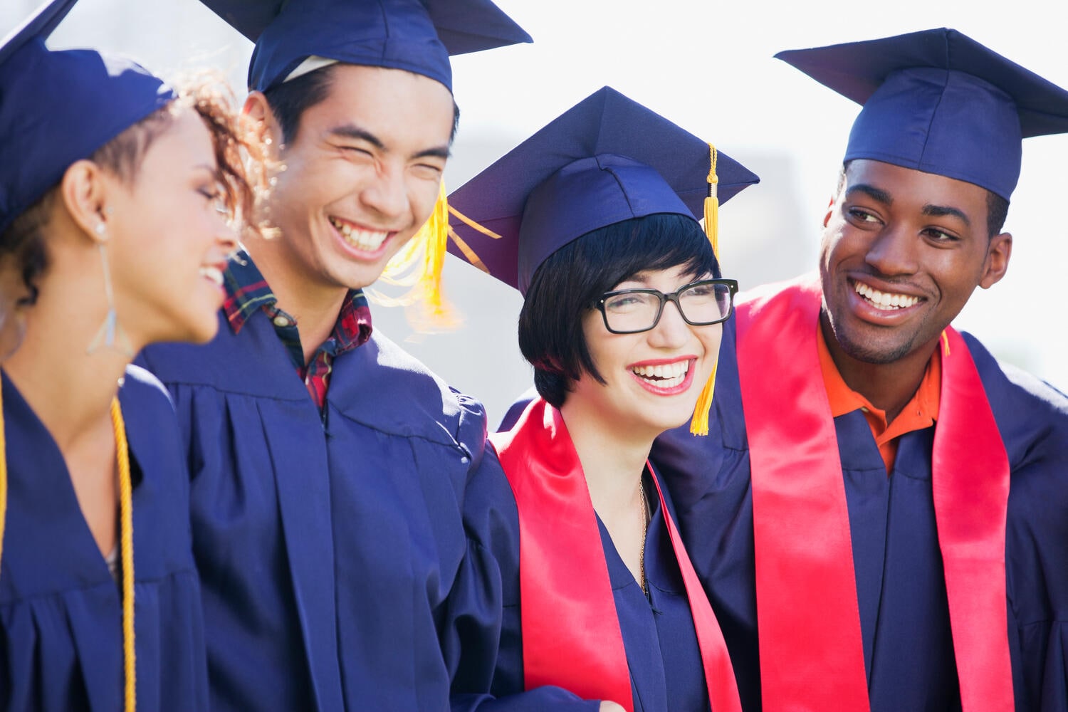 Smiling graduates standing together